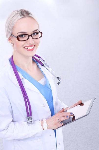 Female doctor using a digital tablet and standing on white background. Woman doctors. - Photo, Image