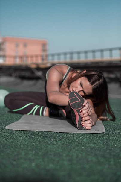 Attractive sporty woman stretching after workout. - Fotoğraf, Görsel