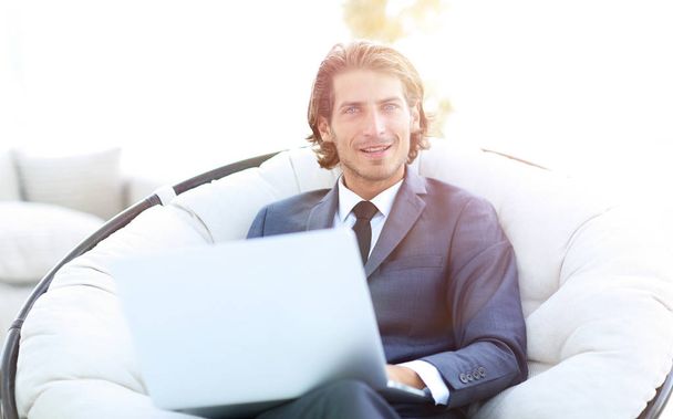 Close-up portrait of a successful business man with a laptop. - Фото, изображение