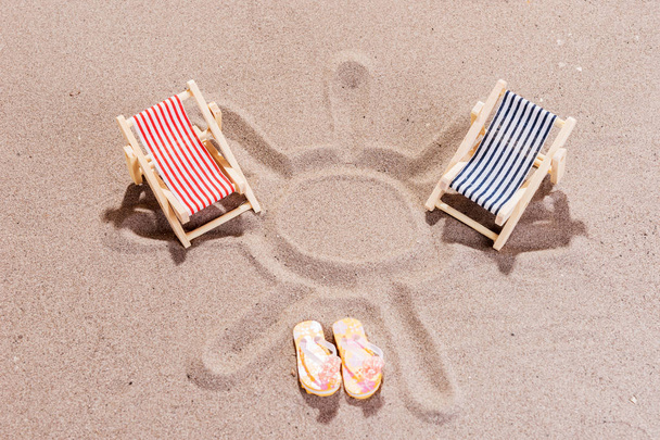 Two colorful sun loungers on the sandy beach - Фото, изображение