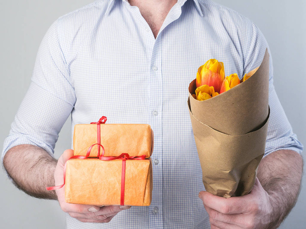 Man with gifts and flowers - 写真・画像