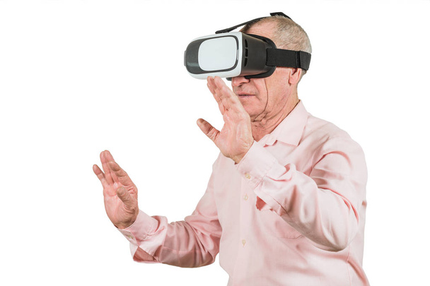Grandfather is looking at the VR sunglasses, gestures with his hands, isolated on a white background - Foto, afbeelding