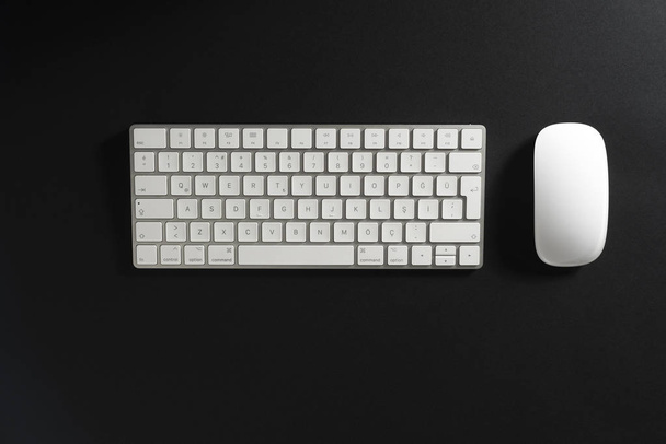 Keyboard and mouse on a black background. - Foto, imagen