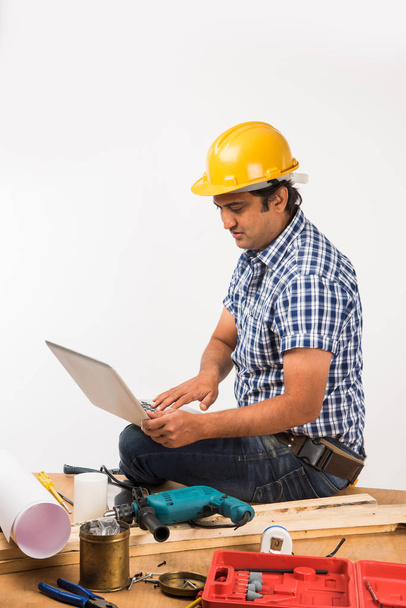 Handsome Indian Carpenter or wood worker in action, isolated over white background - Photo, Image