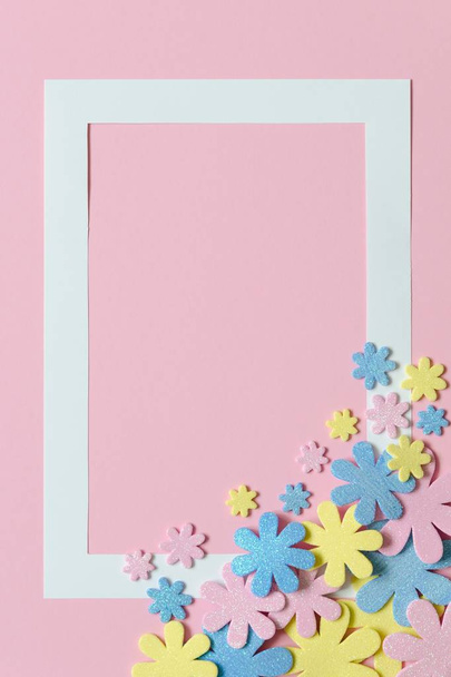 Pink background with colorful flowers and frame for text. - Foto, imagen