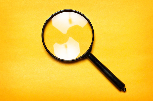 Magnifying glass on yellow background - Φωτογραφία, εικόνα