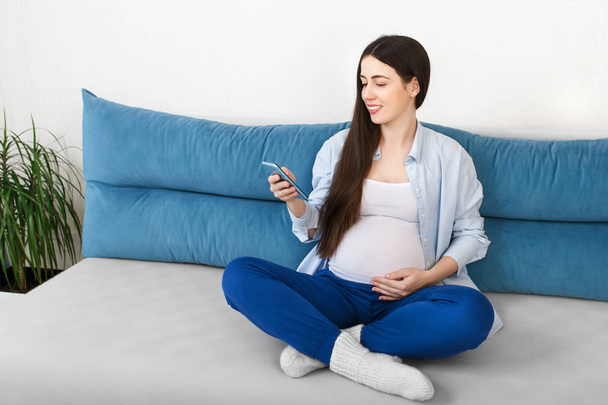 pregnant woman using smartphone - Фото, зображення