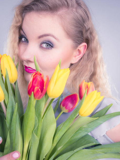 Pretty woman with red yellow tulips bunch - Fotó, kép