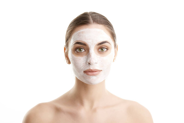 Close-up studio shot of young woman wearing a face mask against at isolated white background with copy space.  - Valokuva, kuva