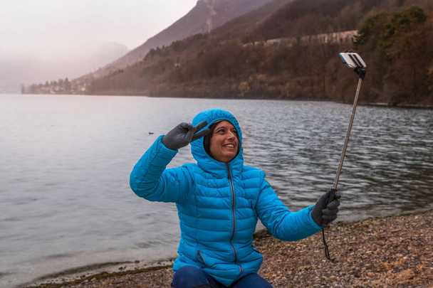 young woman takes a selfie on the shore - Zdjęcie, obraz