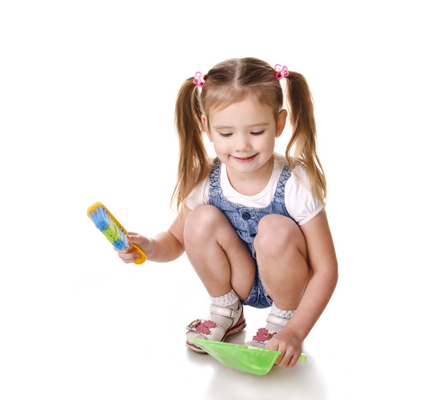 Cute little girl sweeps a floor isolated - Zdjęcie, obraz