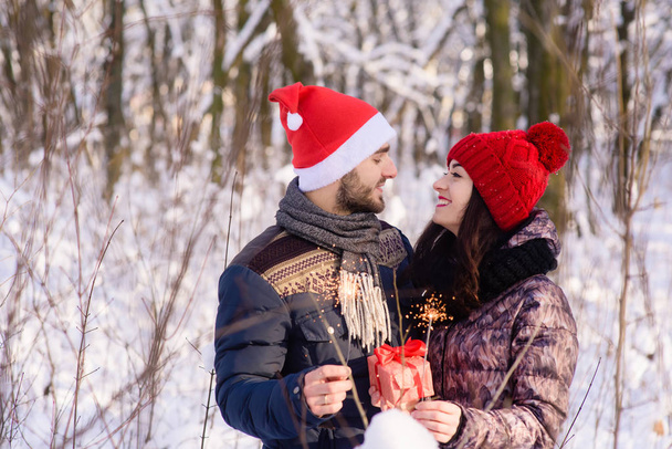 Genç çift bengals ile ve hediye kışın birbirlerine gülümseme - Fotoğraf, Görsel