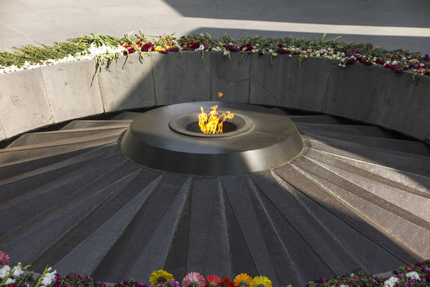 Armenian genocide memorial monument with eternal flame and flowe - Photo, Image