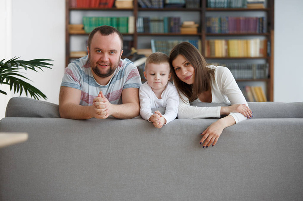 Image of happy woman and man with boys on gray sofa - Photo, Image
