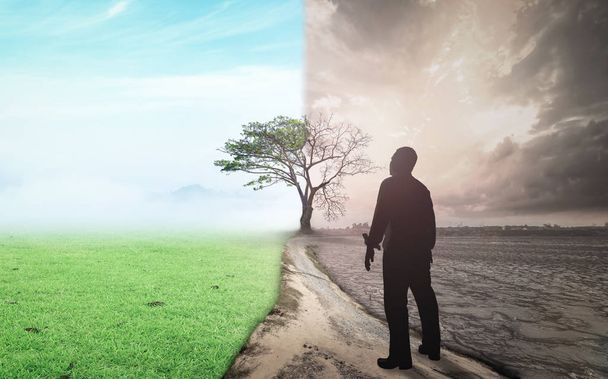 Koncepcja dzień ziemi: biznes człowiek stoi między klimatem pogorszony z dobrą atmosferą - Zdjęcie, obraz