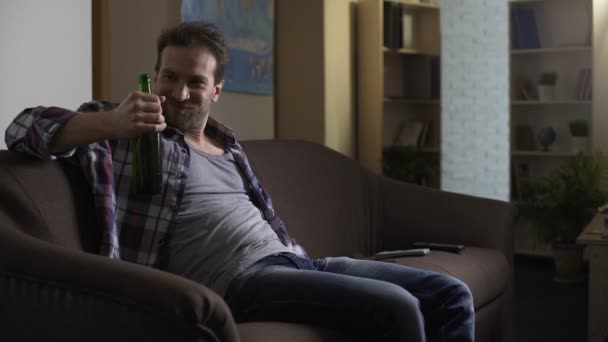 Untidy man drinking beer with content, rubbing belly, addiction to alcohol - Felvétel, videó