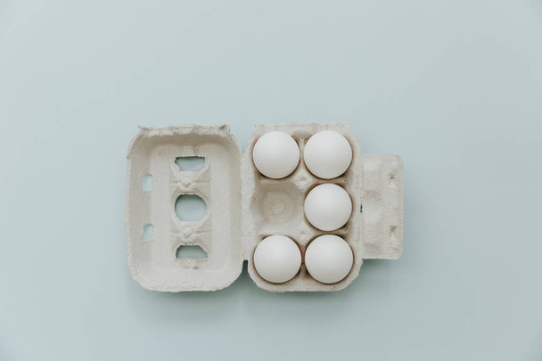 Fresh eggs over minimal pastel background - Photo, Image