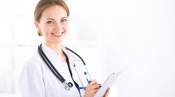 Woman doctor standing with folder at hospital  - Fotografie, Obrázek