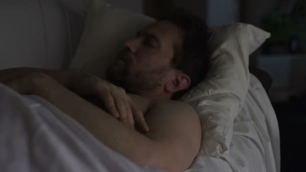 Drunken man sleeping on couch dreaming something bad, having hiccups in sleep - Felvétel, videó