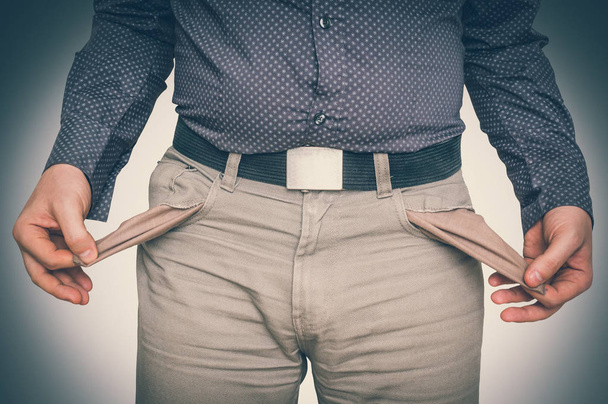 Man pulling out empty pockets - poor people concept - Photo, Image