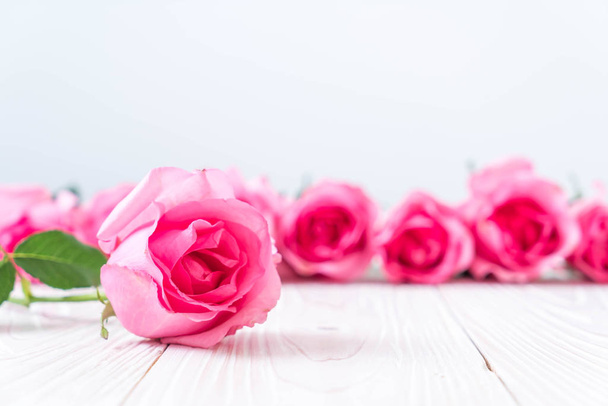 pink rose in vase on wood background - Photo, Image