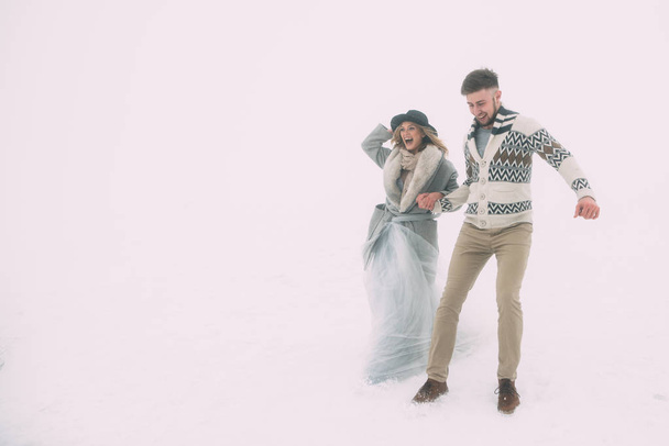 Photo of happy man and woman outdoor in winter - Foto, afbeelding