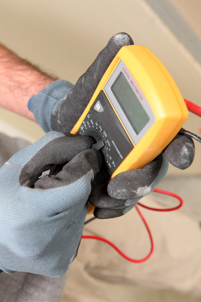 Electrician holding a voltmeter - Photo, Image