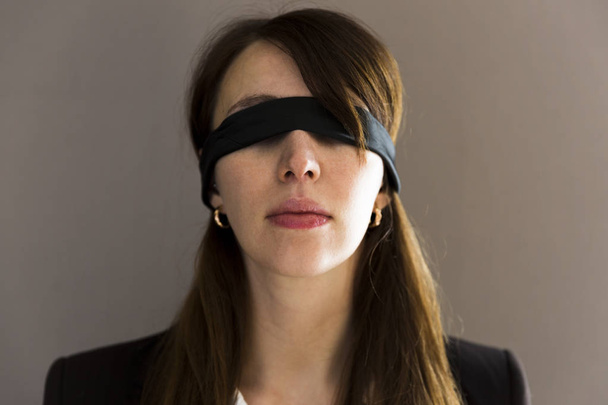 Blind young businesswoman on grey background - Photo, image