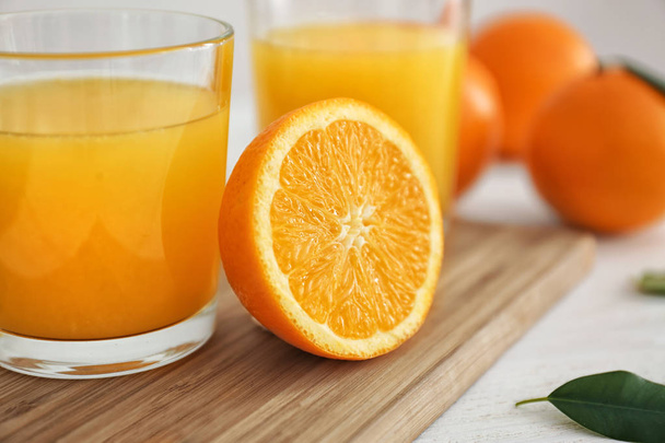 Glass with fresh orange juice and fruit on wooden board - Fotografie, Obrázek
