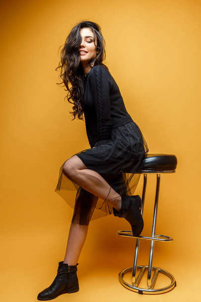 Young stylish woman on chair - Fotó, kép