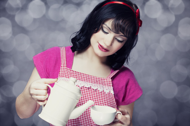 Brunette women with teapot and cup. - Fotoğraf, Görsel