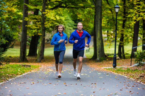 Healthy lifestyle - woman and man running - Valokuva, kuva