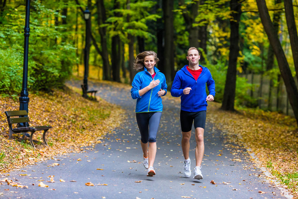 Healthy lifestyle - woman and man running - Zdjęcie, obraz