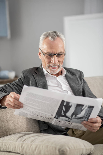 Positive delighted businessman reading news - Foto, Imagen