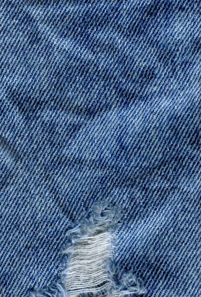 Blauw denim jean textuur achtergrond. Jeans gescheurd stof textuur - Foto, afbeelding