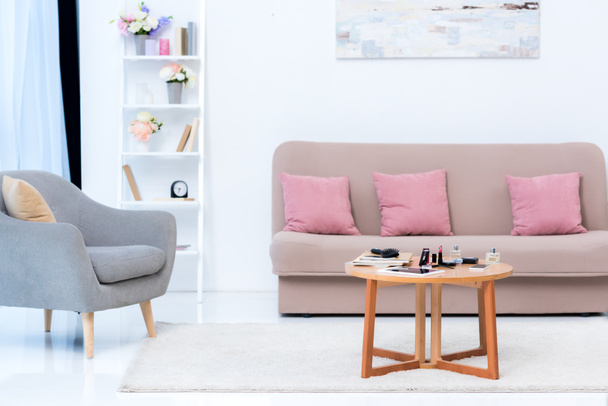 cozy stylish interior and various cosmetics on table - Foto, afbeelding