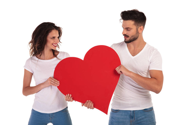happy man and woman holding a heart  - Фото, зображення
