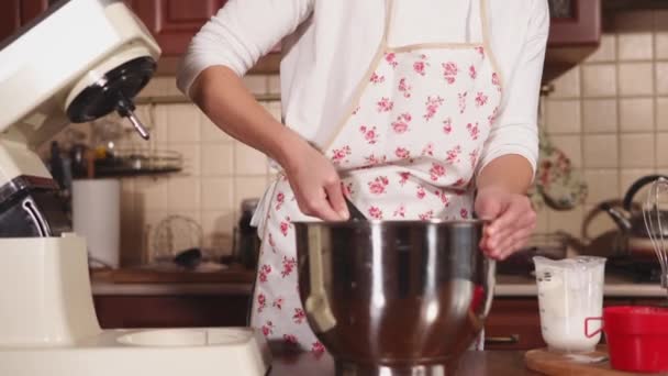 Housewife is mixing ingredients in a big metal bowl in kitchen - Filmagem, Vídeo