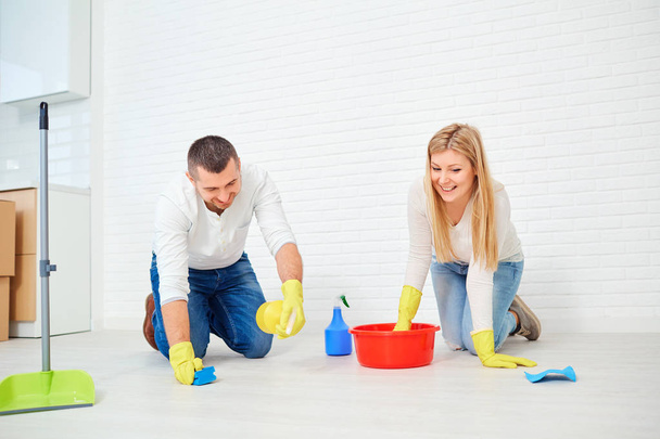 A couple washes the floor. - Фото, зображення