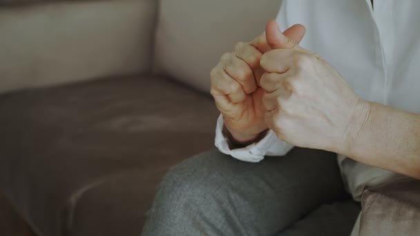 Close-up of woman nervously moving and gesturing hands before meetting with psychologist sitting on couch in office - Filmmaterial, Video