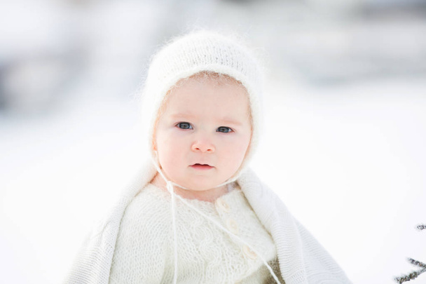 Beautiful mother in white dress and cute baby boy in knitted one - Photo, image