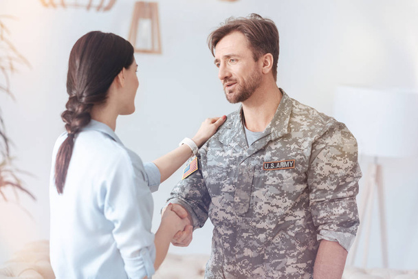Grateful military man saying words of appreciation after psychotherapy session - 写真・画像