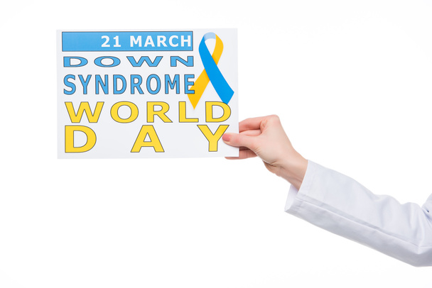 Female hand holding paper with Down Syndrome World Day inscription isolated on white  - Foto, Imagem