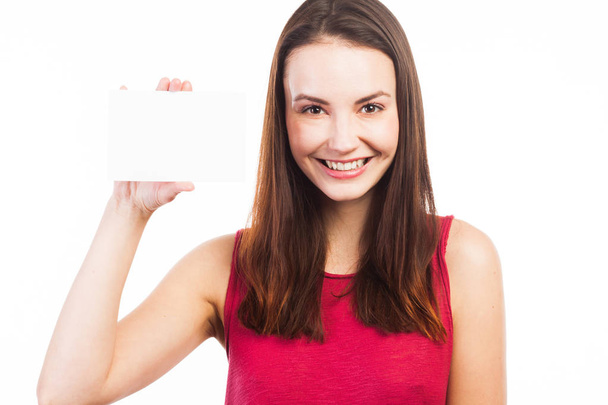 Joyful young woman showing a blank card - 写真・画像