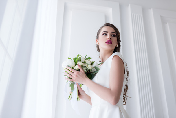 young bride posing in traditional white dress with wedding bouquet - Foto, Imagem