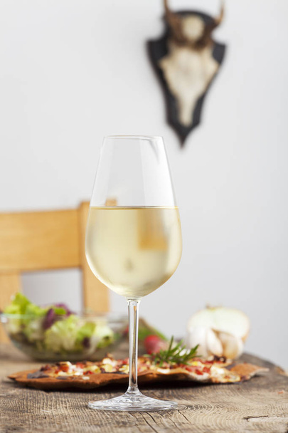 Закри біле вино в келихах з смачні домашні італійська піца на тлі - Фото, зображення