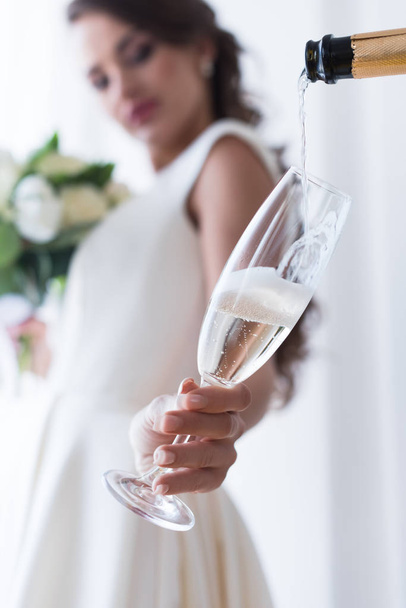 selective focus of bride holding glass of champagne - Foto, imagen