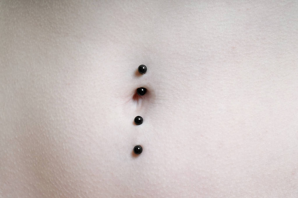 belly button or navel pierced with double barbell piercing - Photo, Image