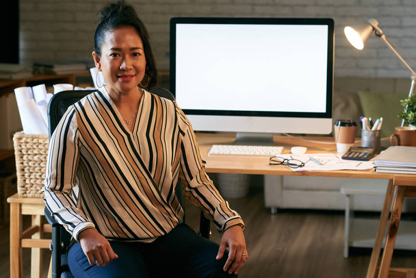 Portrait of pretty Indonesian female entrepreneur in her office - Photo, Image