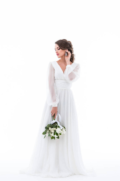 tender bride posing in elegant dress with wedding bouquet, isolated on white - Фото, зображення